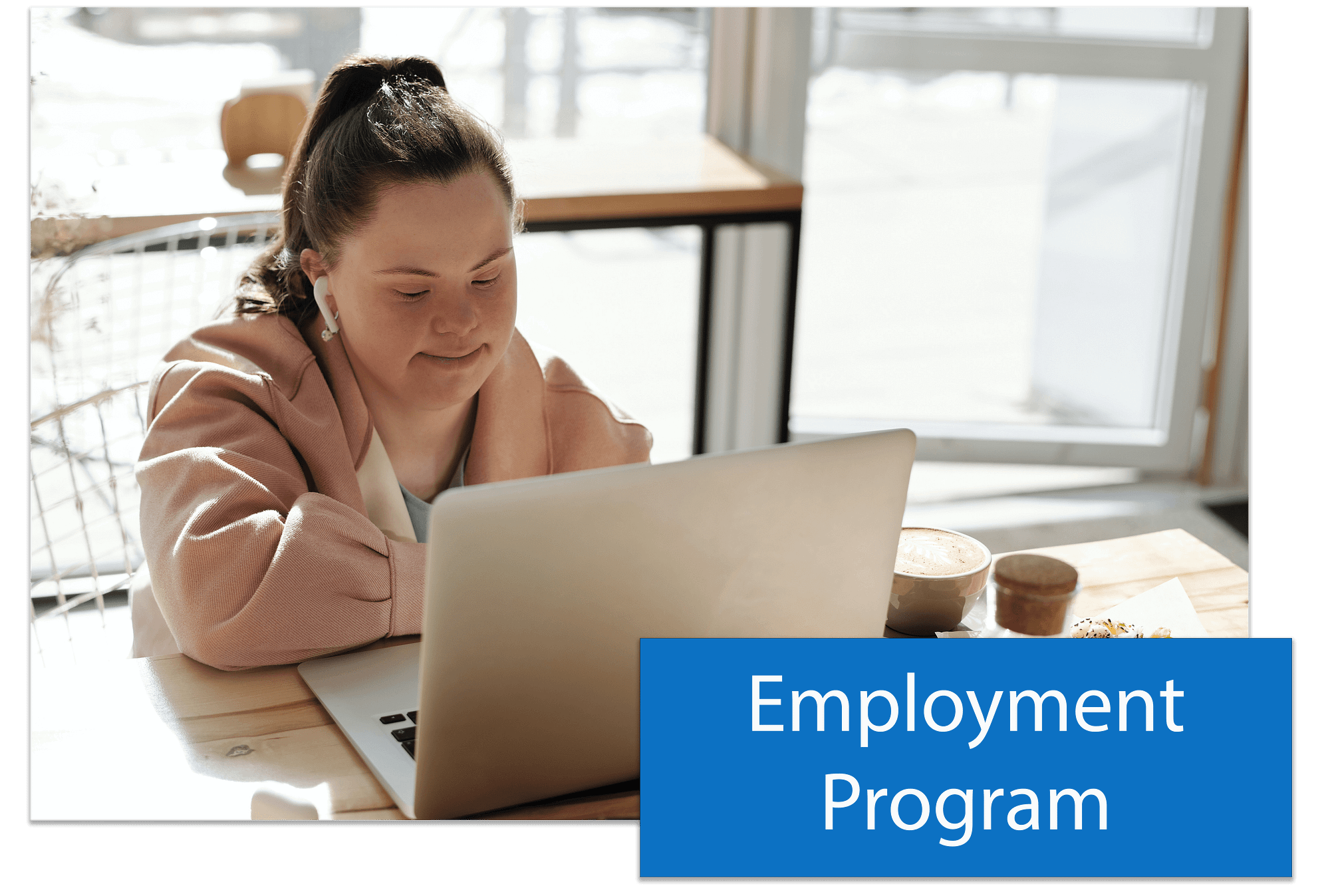 A button that says Employment Program placed in the lower right hand corner of an image of a woman with Downs Syndrome working on a laptop at a desk.