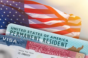 A green card edge is shown in front of an American flag.