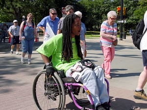 man crossing street in wheelchair