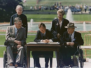 President George Bush signs the ADA into Law, July 1990